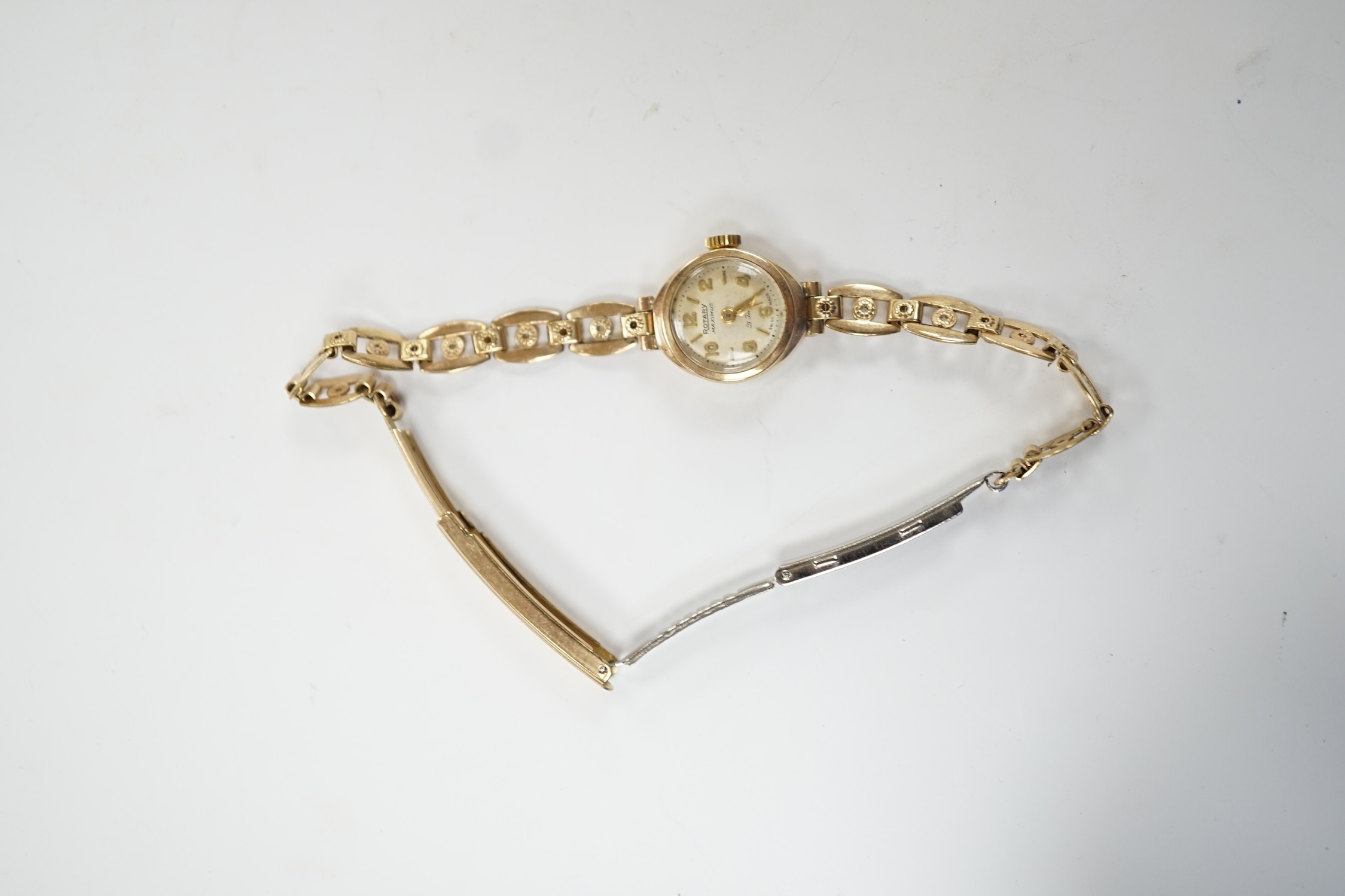 A lady's 9ct gold Rotary Maximus manual wind wrist watch, on a rolled gold bracelet. Fair condition.